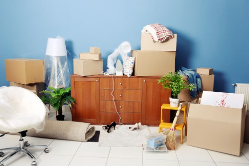 Flat removals team planning a move in Kentish Town street with apartment access