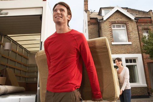 Moving crew carrying items through a residential street in Kentish Town