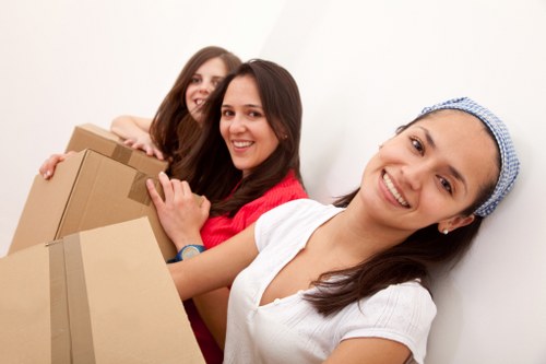 Local movers handling boxes near a Kentish Town flat