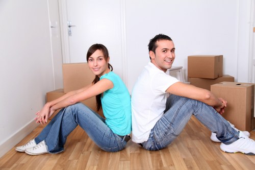 Removal workers carrying furniture through a Kentish Town apartment building
